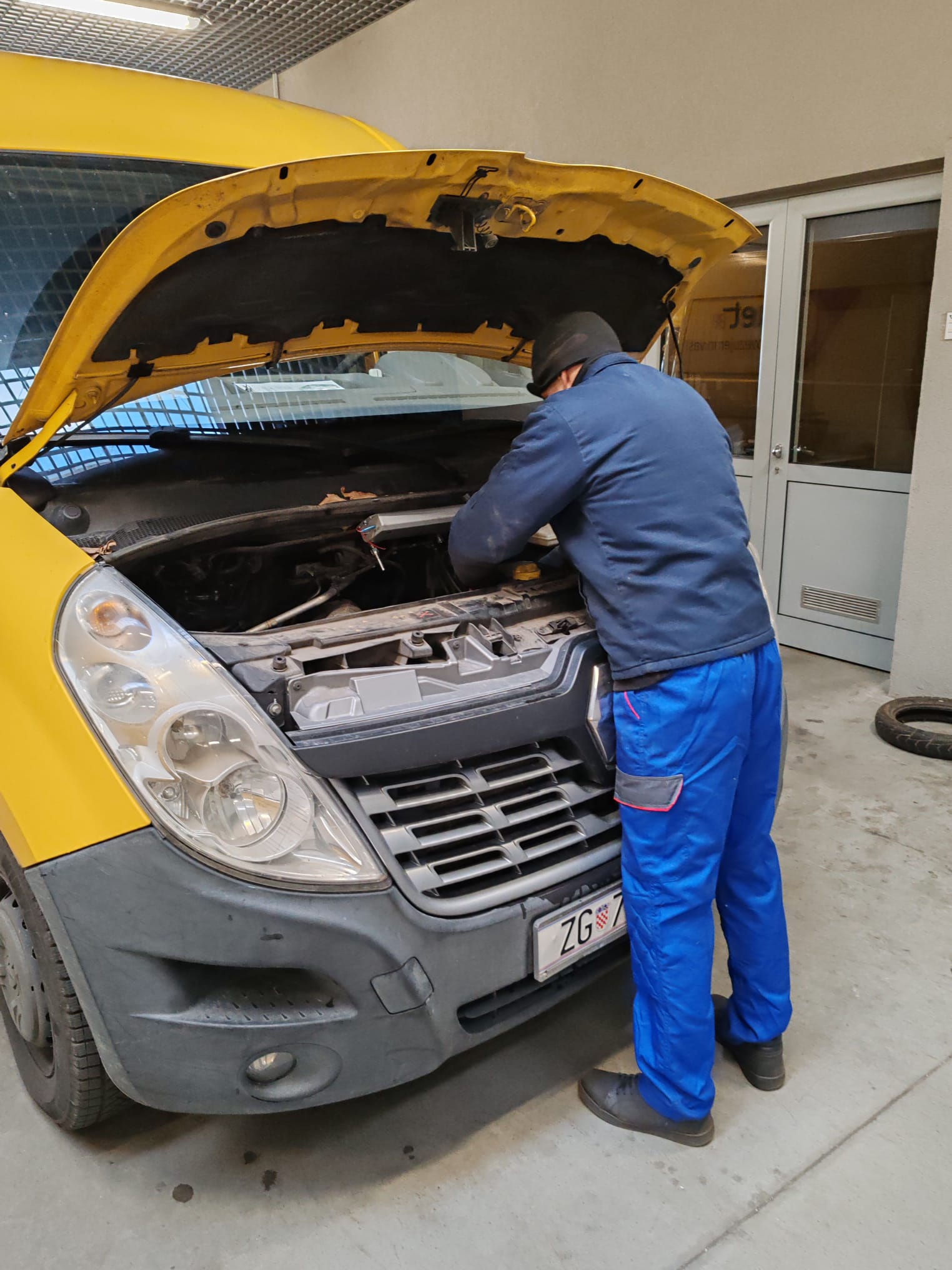 Technician fitting the unit on a delivery van